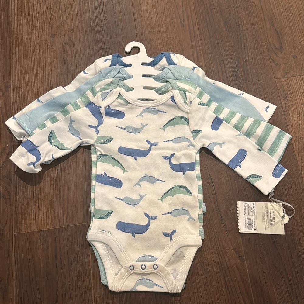 Four pack long sleeve bodysuits new with tags 0-3 months